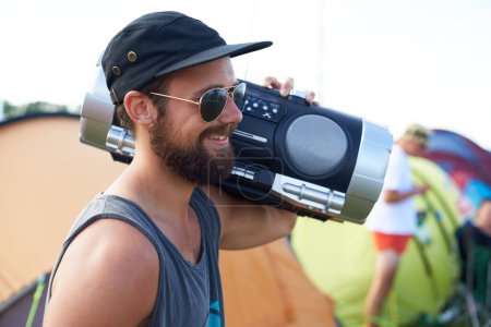 Photo for Radio, outdoor or happy man in music festival for party, event or concert with energy or listening. Rave, retro or person with smile, wellness or audio technology for techno, freedom or celebration. - Royalty Free Image