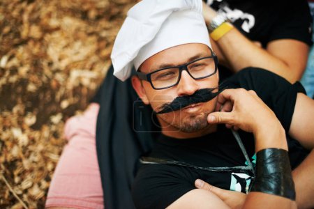 Photo for Face, thinking and a man in a chef costume outdoor at a music festival for celebration or performance. Idea, relax or funny and a young person at a carnival for an event or show with his friends. - Royalty Free Image