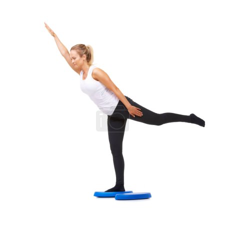 Photo for Balance, health and stretching with woman on disk in studio for workout, mindfulness or exercise. Wellness, challenge and training with person on white background for flexibility and aerobics. - Royalty Free Image
