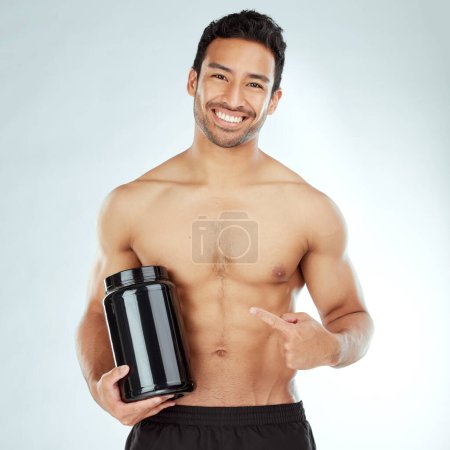 Photo for Face, body and fitness man hand pointing to protein in studio for workout recovery suggestion on white background. Product, whey or nutritionist show Weight loss, muscle growth or supplement support. - Royalty Free Image