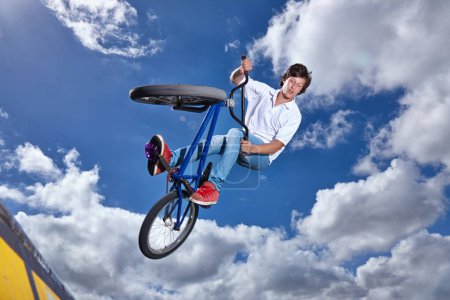 Photo for Trick, jump and man with bike in sky at park, event or competition for sport with risk, energy or freedom. Mockup, space or person in air with fearless stunt on bicycle for fun adventure in summer. - Royalty Free Image