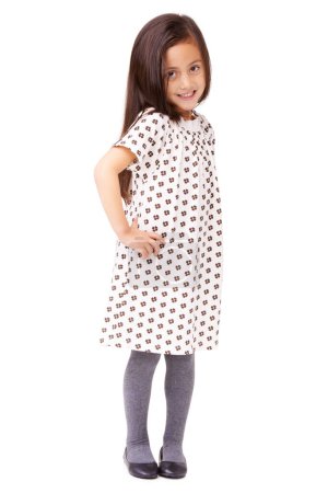 Photo for Happy, child or portrait with smile or fashion on white background in studio with confidence. Hands on hips, cute female kid or full body of young girl in Italy with dress, pride or clothes in style. - Royalty Free Image