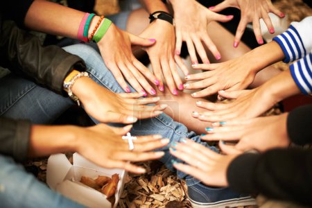 Photo for Hands, manicure and a group of girl friends outdoor at a music festival sitting in a circle from above. Party, event and hipster people on the ground at a concert, show or performance together. - Royalty Free Image