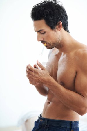 Photo for Handsome man, cigarette and smoking for addiction, drag or tobacco against a white studio background. Face of young and attractive male person, model or smoker addict relax shirtless in stress relief. - Royalty Free Image