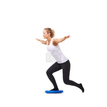 Photo for Balance, health and training with woman on disk in studio for workout, body or exercise. Wellness, challenge and fitness with female person on white background for flexibility, active or aerobics. - Royalty Free Image