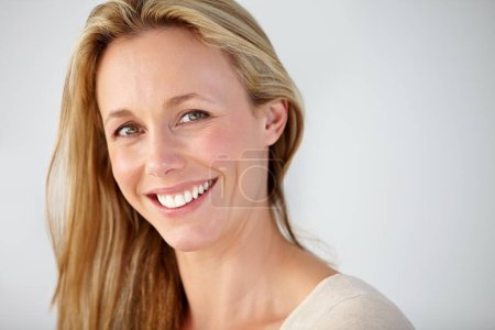 Photo for Portrait, smile and mature woman in studio with natural beauty for break, rest and confident personality on white background. Face of happy model with good mood, pride and optimism at mockup space. - Royalty Free Image