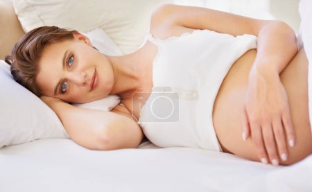 Photo for Pregnant woman, love stomach and portrait on bed with relax wellness and mindfulness for prenatal care. Person, smile face and connect for pregnancy gratitude, rest and maternity touch in apartment. - Royalty Free Image