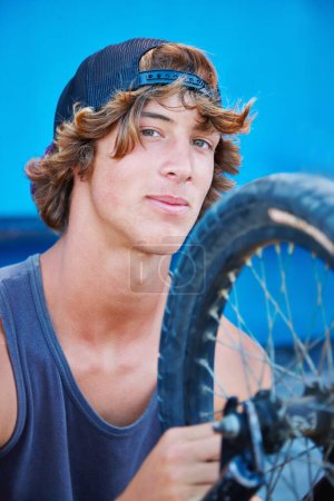 Photo for Bicycle, tire and portrait of man outdoor at skatepark in summer with maintenance, repair or inspection. Bike, care and person fixing wheel or cyclist check air in tyre for performance in cycling. - Royalty Free Image