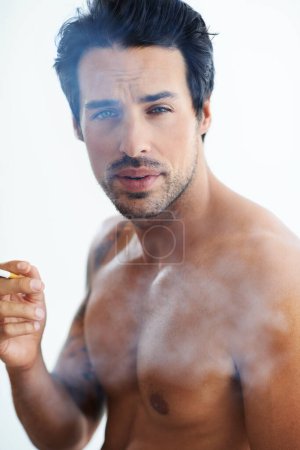 Photo for Handsome man, portrait and smoking cigarette in addiction, drag or tobacco against a white studio background. Face of attractive male person, model or shirtless addict smoker in stress relief smoke. - Royalty Free Image