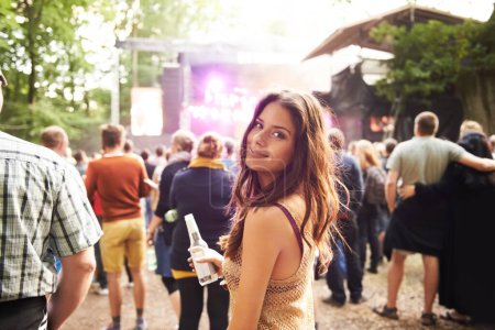 Photo for Woman, portrait and drink at outdoor music festival with crowd for party or event in nature. Face of female person smile and enjoying sound or audio at carnival, concert or performance outside. - Royalty Free Image