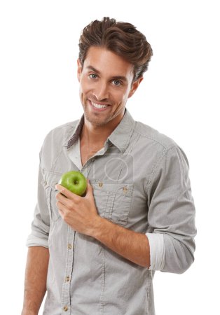 Photo for Portrait, smile and man with apple, food and healthy diet isolated on a white background in studio. Face, happy person and green fruit for nutrition, vegan and wellness benefits, vitamin c or organic. - Royalty Free Image