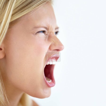 Photo for Angry, face or woman screaming in studio at mockup space for crisis, mad emoji or reaction on white background. Frustrated model, shouting or voice of anger, emotional conflict or negative expression. - Royalty Free Image