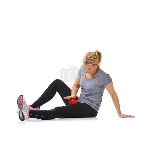 Photo for Woman, massage ball and healing body or rehabilitation, injury and health or wellness by white background. Female person, athlete and physical therapy in studio for muscles in legs and body in mockup. - Royalty Free Image