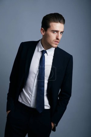 Photo for Portrait, fashion and man with business, employee and confident guy on a grey studio background. Person, corporate and model with suit, elegant outfit and stylish clothes with professional and worker. - Royalty Free Image