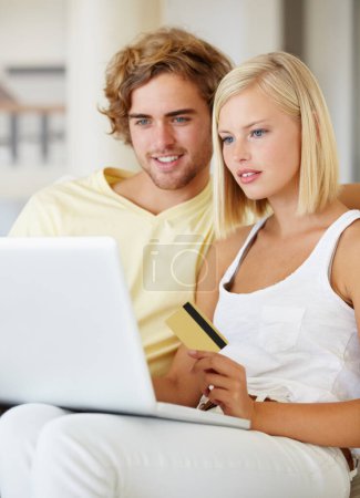 Photo for Couple, credit card and laptop for online shopping, loan registration or digital money on sofa at home. Young woman and man relax on computer for internet banking, website payment or e commerce order. - Royalty Free Image