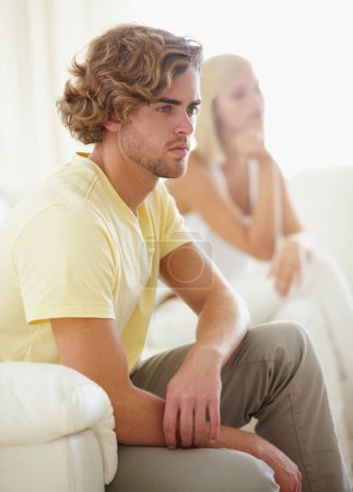 Angry couple, fight and divorce stress on a sofa with argument, anxiety or cheating depression in their home. Marriage crisis, dispute and overthinking man ignore frustrated woman in a living room.