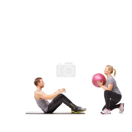 Photo for Coaching, man and woman with gym ball for pilates in studio, body fitness and support. Sports workout, fit girl and personal trainer with sphere for balance, training and power on white background - Royalty Free Image