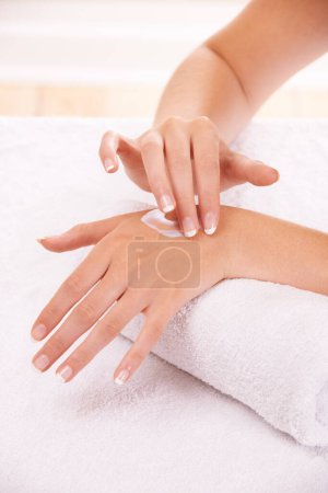 Photo for Skin, apply cream and hands in spa, closeup and massage on towel for care. Touch fingers, nails and woman on lotion treatment, natural cosmetics or dermatology moisturizer, beauty health or manicure. - Royalty Free Image
