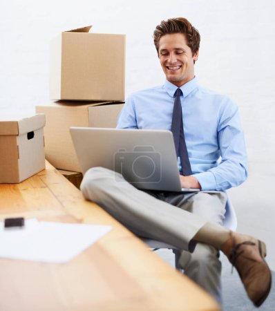 Photo for Business man, shipping boxes and happy by laptop, entrepreneur and online logistics for courier. Male person, professional and delivery for company distribution, package and technology or internet. - Royalty Free Image