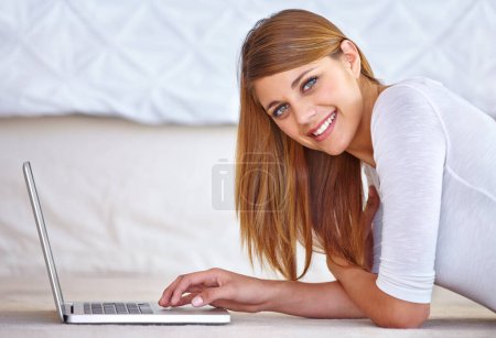 Photo for Happy woman, remote work and portrait with laptop on floor of home to update blog post, social media and digital subscription. Freelancer typing on computer for online shopping, email and technology. - Royalty Free Image