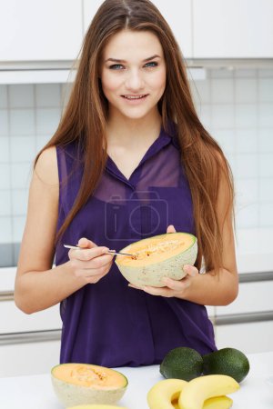 Photo for Papaya, fruit and portrait of woman in kitchen with health, nutrition and diet in home. Happy, person and cantaloupe for breakfast, snack or healthy food in morning to digestion, detox or benefits. - Royalty Free Image