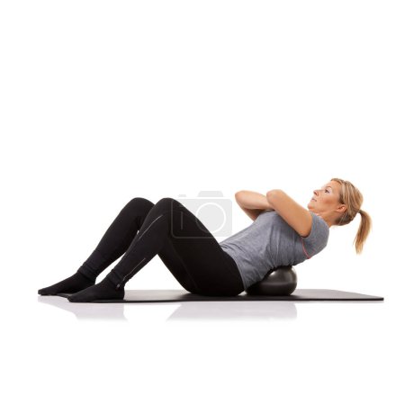 Photo for Sit up, exercise and woman on floor with ball for pilates, body building care and health in studio. Gym, training and girl on mat with cardio, energy and muscle workout isolated on white background - Royalty Free Image
