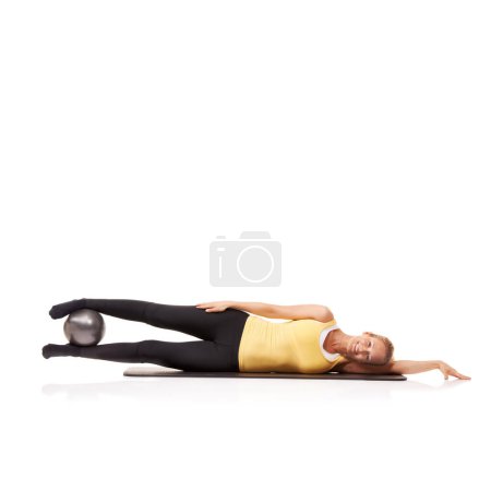 Photo for Woman, portrait and ball or legs balance on side for squeeze abductor, strong thighs or white background. Female person, face and equipment in studio for health training, gym muscle or mockup space. - Royalty Free Image
