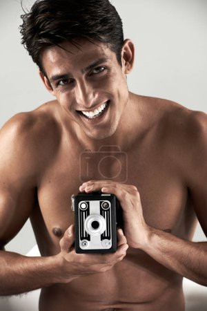 Photo for Shirtless, man and portrait with vintage camera for sexy, photography or recording happiness. Muscular, model and smile with retro photographer, hobby or topless person with creative film project. - Royalty Free Image