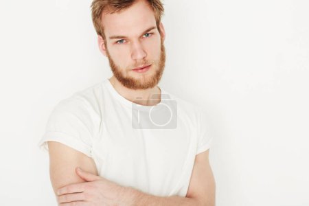 Photo for Man, portrait and confident or fashion in studio with casual style, trendy outfit and calm expression. Person, face and relaxing, t-shirt and satisfaction with peace and pride on white background. - Royalty Free Image