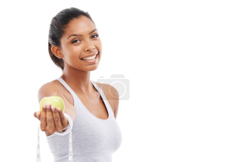 Photo for Woman, portrait and lose weight with a measuring tape and apple in white background, studio or mockup. Happy, model and healthy food for results in fitness, wellness and diet with nutrition and fruit. - Royalty Free Image
