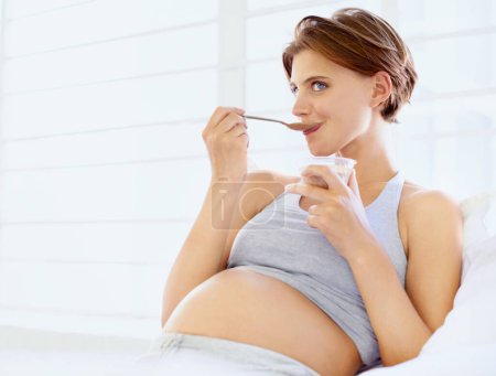 Photo for Breakfast in bed, eating and pregnant woman with chocolate pudding in a house, calm and hungry. Sugar, face and female person in bedroom with pregnancy nutrition for health, balance or utero wellness. - Royalty Free Image