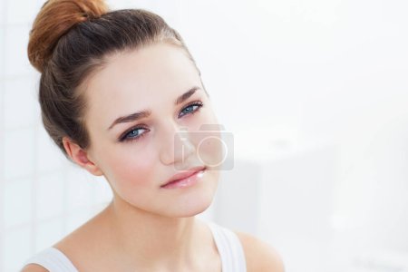 Photo for Skincare, portrait and woman in a bathroom with cosmetics, wellness or glowing skin treatment at home. Beauty, face and female person in a house with shine, dermatology or natural makeup results. - Royalty Free Image