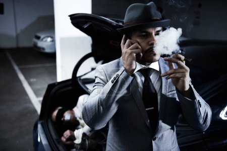 Photo for Mafia, car and man with hostage in trunk for negotiation, kidnapping ransom and crime. Business, gangster criminal smoking and person in boot for abduction, danger and robbery in parking lot or smoke. - Royalty Free Image