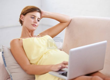Photo for Thinking, pregnant and woman on laptop in house living room for childcare website, information and reading. Vision, ideas and relax person on home sofa with technology, research and pregnancy blog. - Royalty Free Image