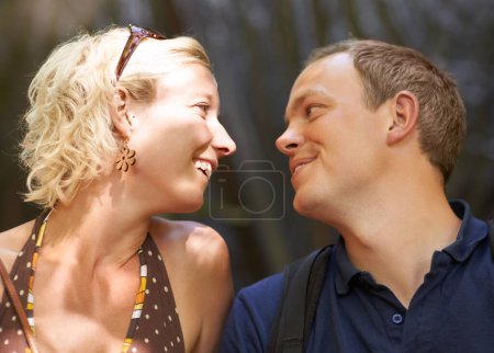 Photo for Smile, love and couple together outdoor, healthy relationship and connection in nature. Happy man, woman and romantic people looking at each other, bonding and support, trust and face profile on date. - Royalty Free Image