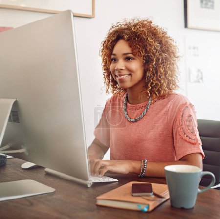 Photo for Workplace, happy or designer with computer for research, editing or copywriting on blog or website. Startup, smile or African woman in office working on internet update, networking or reading news. - Royalty Free Image