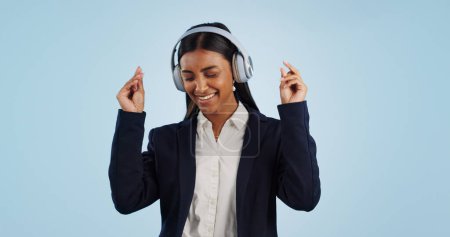 Photo for Headphones, dancing or happy businesswoman in studio for music isolated on blue background. Energy, smile or calm female person streaming a radio song, sound or audio on online subscription to relax. - Royalty Free Image