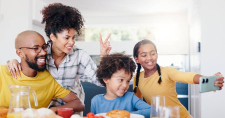 Photo for Selfie, peace sign and a black family eating breakfast in their home kitchen together for health, diet or nutrition. Food, photo or memory with a mother, father and children together in an apartment. - Royalty Free Image