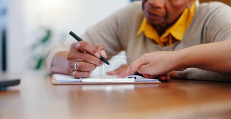 Photo for Senior woman, hands and writing on contract, form or application for retirement plan or insurance at home. Closeup of elderly female person signing documents, paperwork or agreement on table at house. - Royalty Free Image