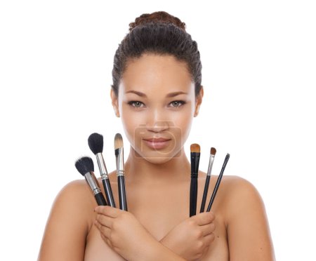 Photo for Woman, portrait and makeup brushes in studio for beauty, foundation and cosmetics for coverage. Face of a young model or artist with skincare, application tools and product on a white background. - Royalty Free Image