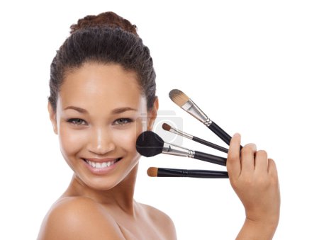 Photo for Makeup, brushes and portrait of happy woman in studio for beauty, foundation and cosmetics. Face of young model, artist and person with skincare, application tools and product on a white background. - Royalty Free Image