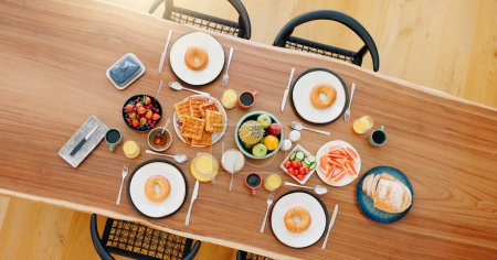 Photo for Healthy, breakfast and food on dining table with top view, fruit and coffee for wellness and nutrition. Morning, brunch and meal with waffles, donut and cutlery for snack or gourmet diet from above. - Royalty Free Image