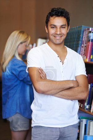 Photo for Portrait, arms crossed or happy man in a library for knowledge or development for future growth. Scholarship, education or male student with smile or pride for studying or learning in college campus. - Royalty Free Image