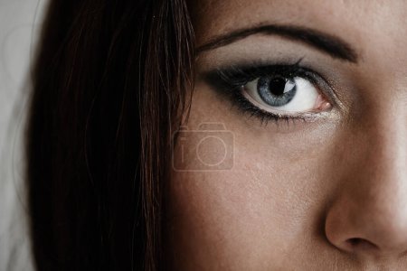 Photo for Woman, beauty and eye in portrait, makeup and cosmetics or edgy aesthetic by studio background. Female model person, half face and skincare or glamour eyeshadow, closeup and eyeliner by backdrop. - Royalty Free Image