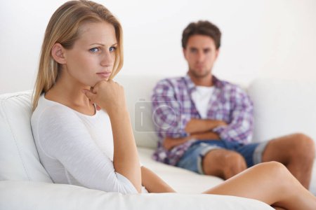 Photo for Couple, angry and living room couch with disagreement, upset and thinking with anger, fight or mad. Divorce, betrayal and relationship with cheating, stress and argument for marriage, home or toxic. - Royalty Free Image