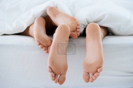 Photo for Couple, morning or feet with blanket in sleeping for peace or rest together on weekend in a house. Wellness, comfort or closeup of barefoot people in home for bond, care or nap under duvet in bedroom. - Royalty Free Image
