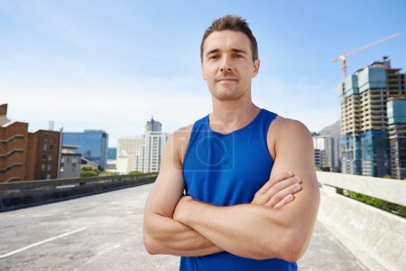 Photo for Man, arms crossed in city and fitness outdoor with workout, training and athlete in portrait for sports. Confidence, face and exercise on urban bridge, health and wellness with sportswear in Chicago. - Royalty Free Image
