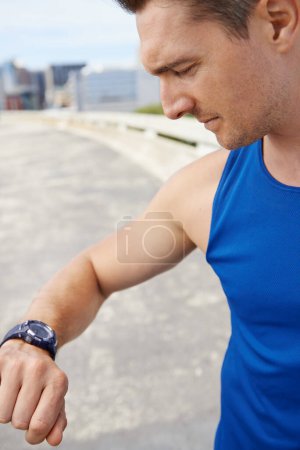 Photo for Man, fitness and looking at watch in city for workout, exercise or monitoring outdoor performance. Closeup of male person or athlete checking wristwatch for training or heart rate in an urban town. - Royalty Free Image