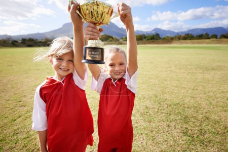 Photo for Celebration, teammates and children with cup, boys and girls with victory, support or proud. Achievement, sports and friendship, together and happy for win, ready for game or physical activity. - Royalty Free Image