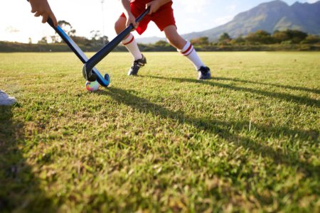 Photo for Children, ball and playing hockey on field for game, sports or outdoor match together. Team, kids or players in competition on green grass for tackle, practice or training in fitness or nature. - Royalty Free Image